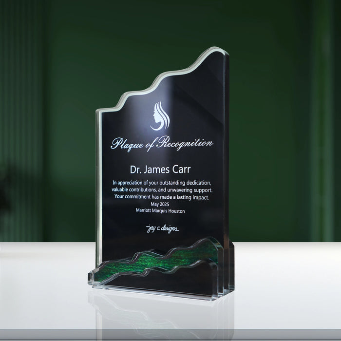 Angled view of an acrylic plaque with a wavy edge and green accent base, featuring a Plaque of Recognition.