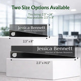 Two black personalized nameplates for human resources managers are displayed on white pedestals with dimension arrows and text indicating two size options available: 2.5