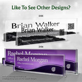 Custom acrylic business nameplates shown in two color options: a black marble pattern with white text on the top model, and a purple wave design with white text on the bottom model. The image includes the names 'Brian Walker' and 'Rachel Morgan' as sample custom text, along with QR codes and model numbers 2105 and 2106.