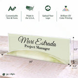 A personalized acrylic nameplate sign with a clear arched base, featuring the text 'Mari Estrada Project Manager' in black script. The image includes dimension annotations (14 inches by 2.