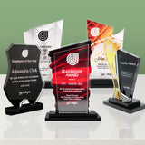 Collection of personalized awards on a reflective surface with a green gradient background with pinnacle shard 8014 at the center