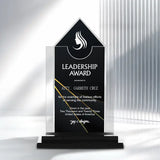 A clear acrylic award trophy with a black front panel reading 'LEADERSHIP AWARD' and personalized text, displayed on a black base against a white background with soft vertical shadows.