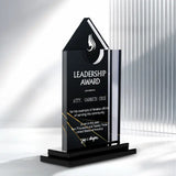 A custom acrylic and glass award trophy for 'Leadership Award' presented to Atty. Garbeth Cruz, featuring a black triangular top, clear glass body, and black tiered base on a white background with vertical light slats.