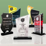 Collection of personalized awards on a reflective surface with a green gradient background with Victory Trophy in the center
