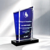 A clear acrylic award plaque trophy with a deep blue front panel and a black rectangular base, shown on a clean white studio background with soft shadows.